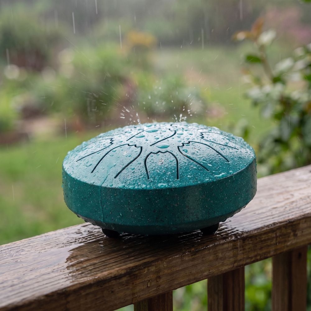 The rain drum on a wet porch rail in the rain